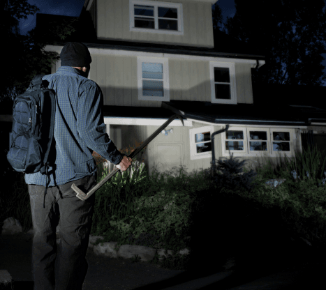 person standing in front of a home at night