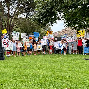 children holding signs at community rally