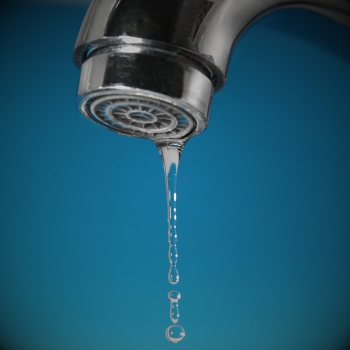 water drop forms on a faucet