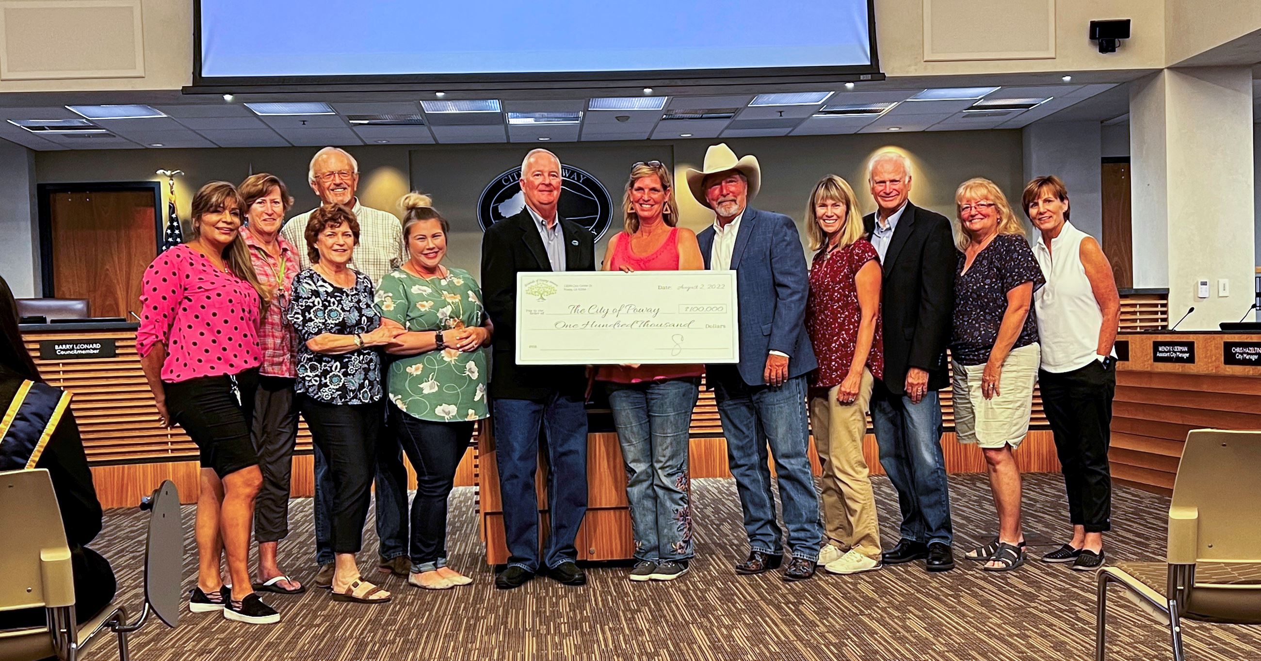 Friends of Poway Seniors board members and Poway City Council members pose with $100K donation check